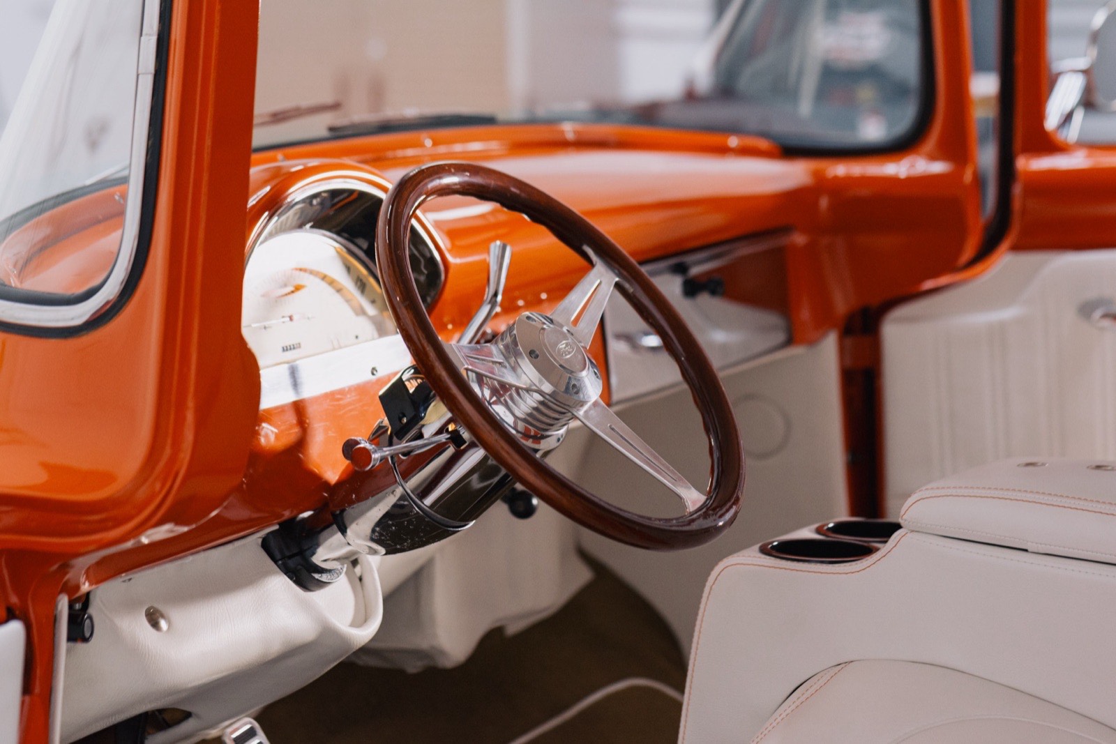 1956 Ford F-100 stepside in vibrant orange, restored by Morgan Muscle Cars in Pelham, Alabama