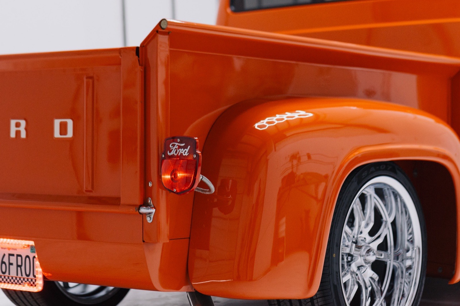 1956 Ford F-100 stepside in vibrant orange, restored by Morgan Muscle Cars in Pelham, Alabama