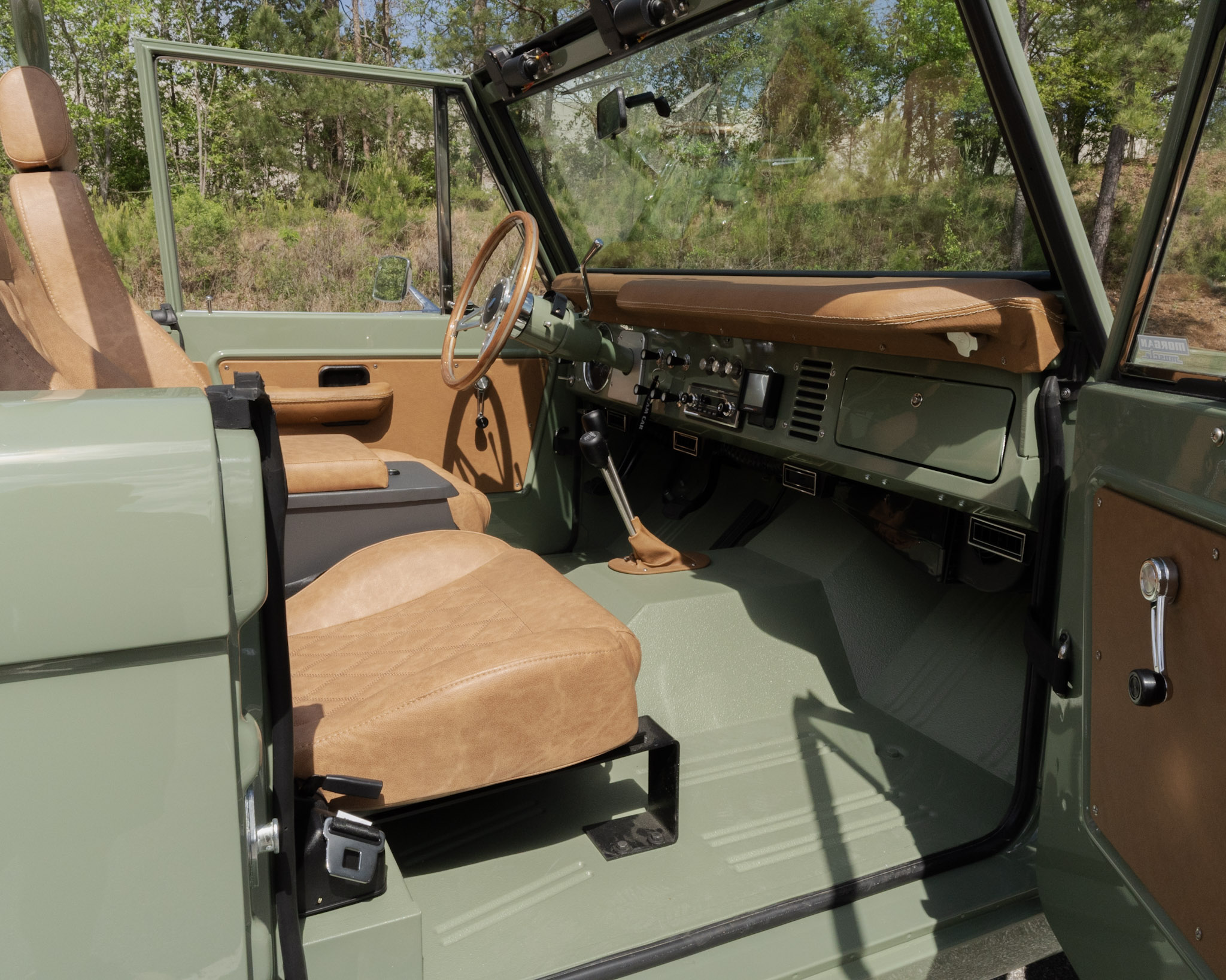1967 Ford Bronco camel leather interior with a body-color Boxwood Green bedlined floor — built by Morgan Muscle Cars in Pelham, Alabama