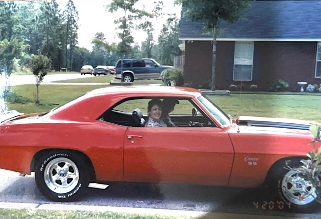 Orange 1969 Chevrolet Camaro SS resto-mod in the driveway, restored by the Morgan family in Pelham, Alabama.