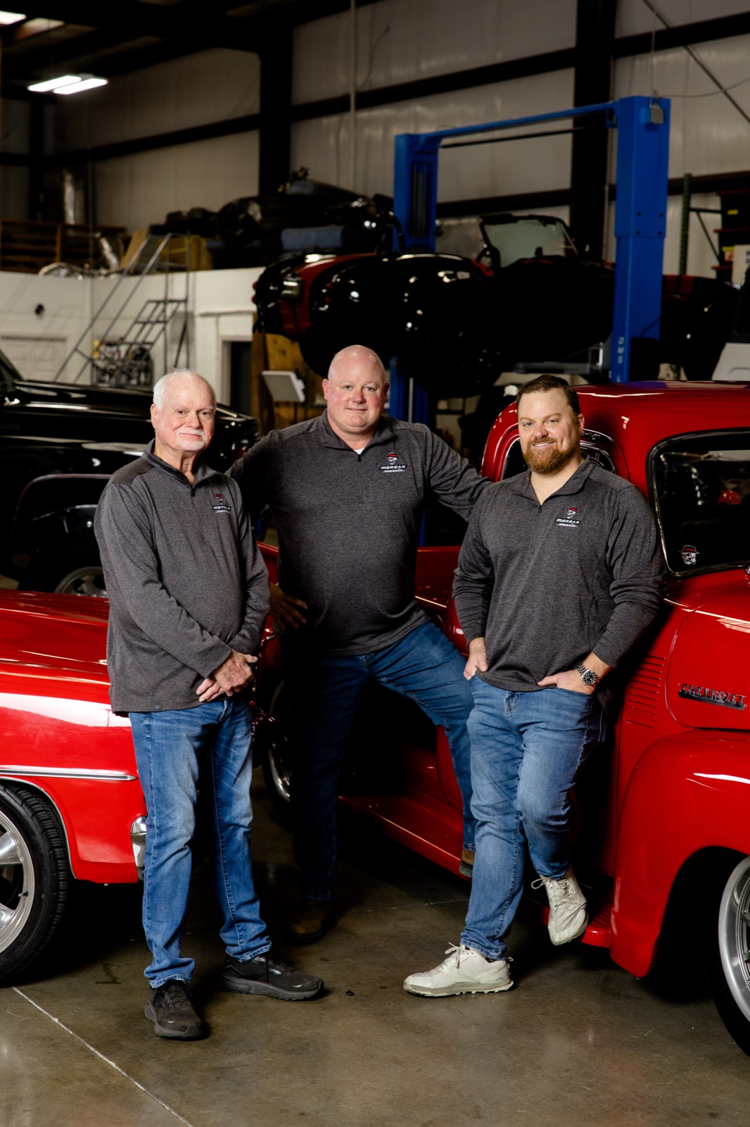 The Morgan family in the shop beside a freshly built classic — Larry 'Paw Paw' Morgan and his sons, Pelham, Alabama.